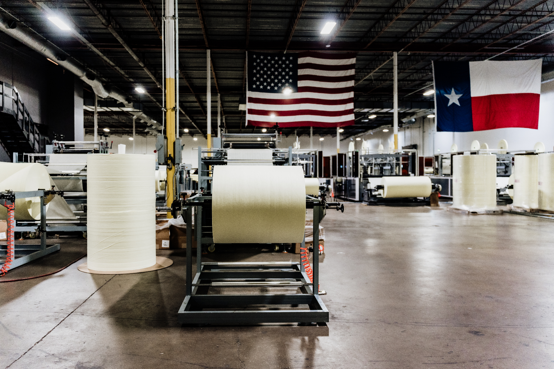Sparrow Engineering Houston production floor with U.S. and Texas flags overhead