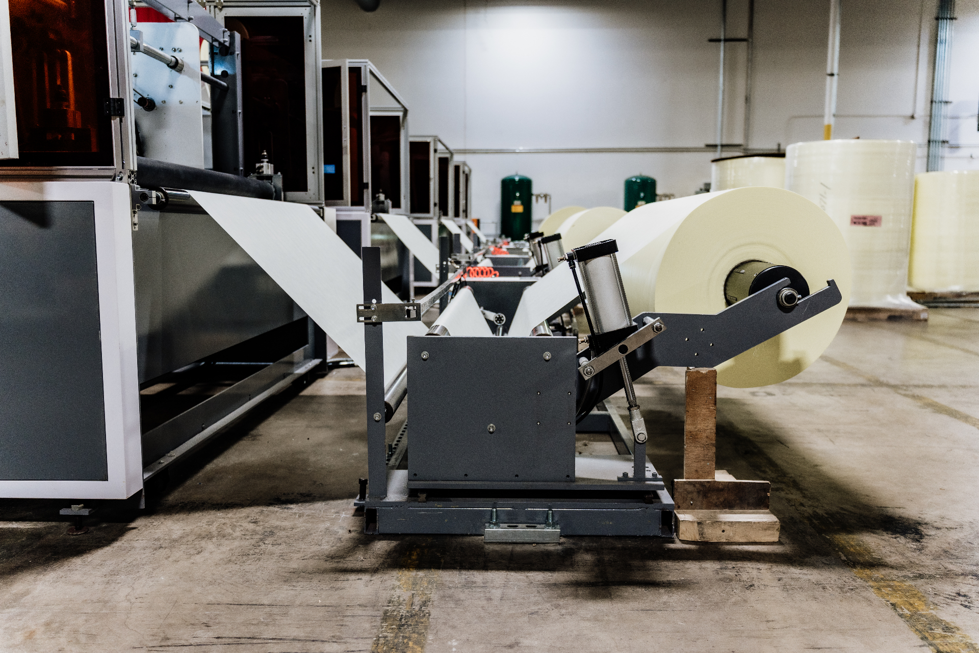 Nonwoven material feeding into an automated gown manufacturing line