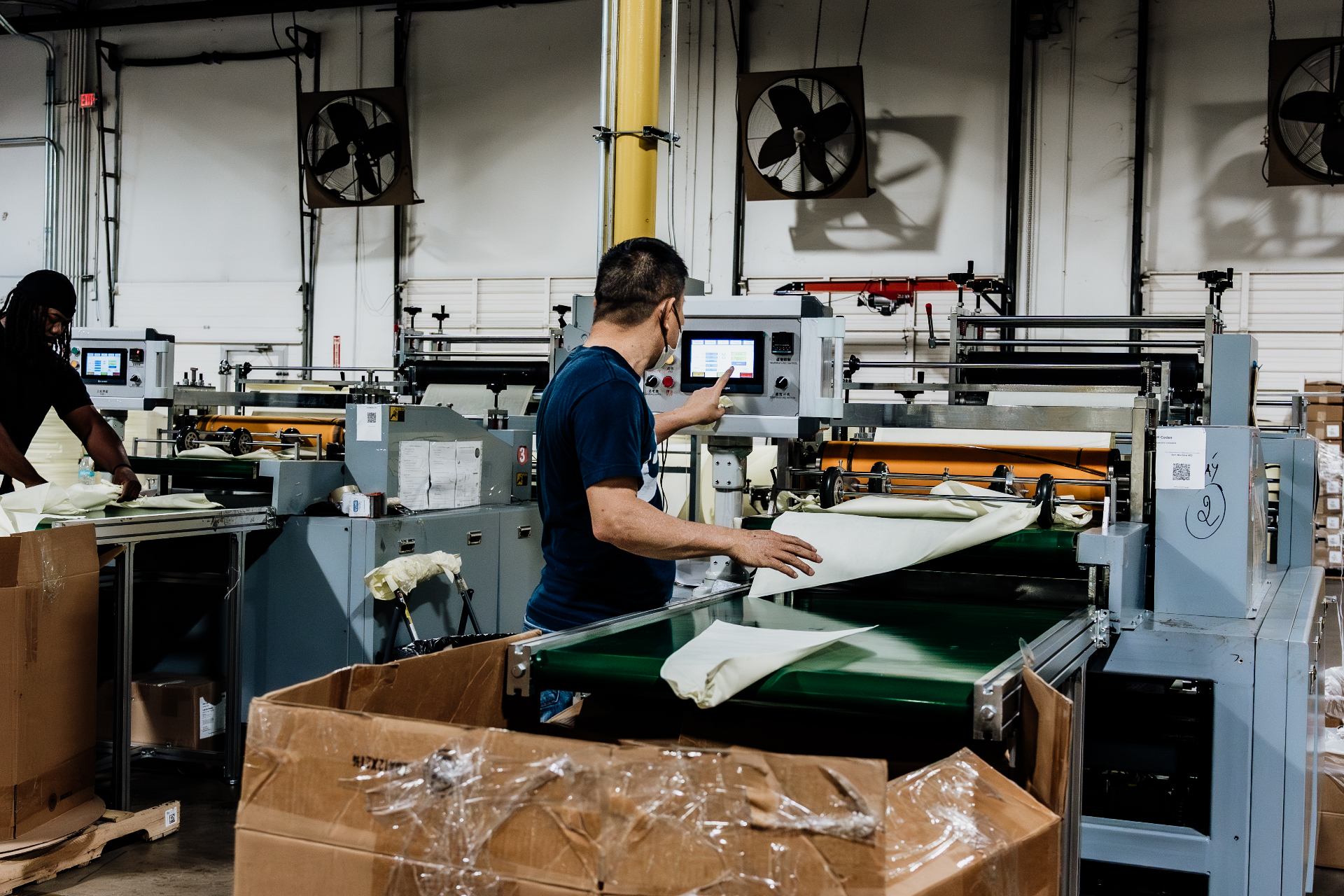 Factory operator running an isolation gown manufacturing line in Houston
